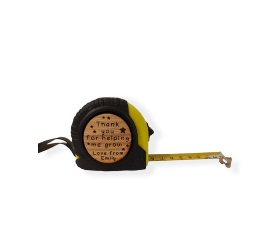 Personalised tape measure with a wooden disc, custom engraved names with your chosen message. This unique, functional gift combines practicality with a fun, stylish touch.