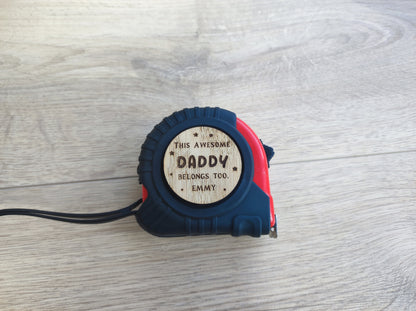 Personalised tape measure with a wooden disc engraved with This Awesome DADDY belongs too...
