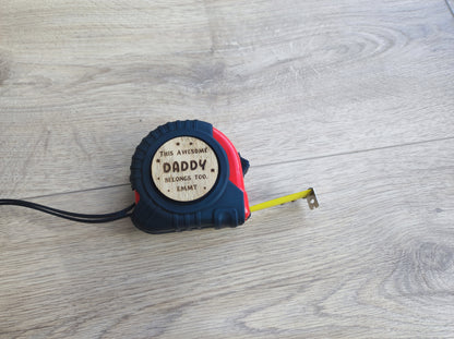 Personalised tape measure with a wooden disc engraved with This Awesome DADDY belongs too...