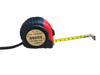 Personalised tape measure with a wooden disc engraved with This Awesome DADDY belongs too...