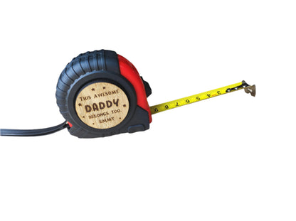 Personalised tape measure with a wooden disc engraved with This Awesome DADDY belongs too...