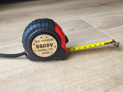 Personalised tape measure with a wooden disc engraved with This Awesome DADDY belongs too...