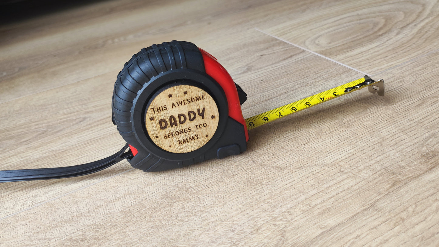Personalised tape measure with a wooden disc engraved with This Awesome DADDY belongs too...