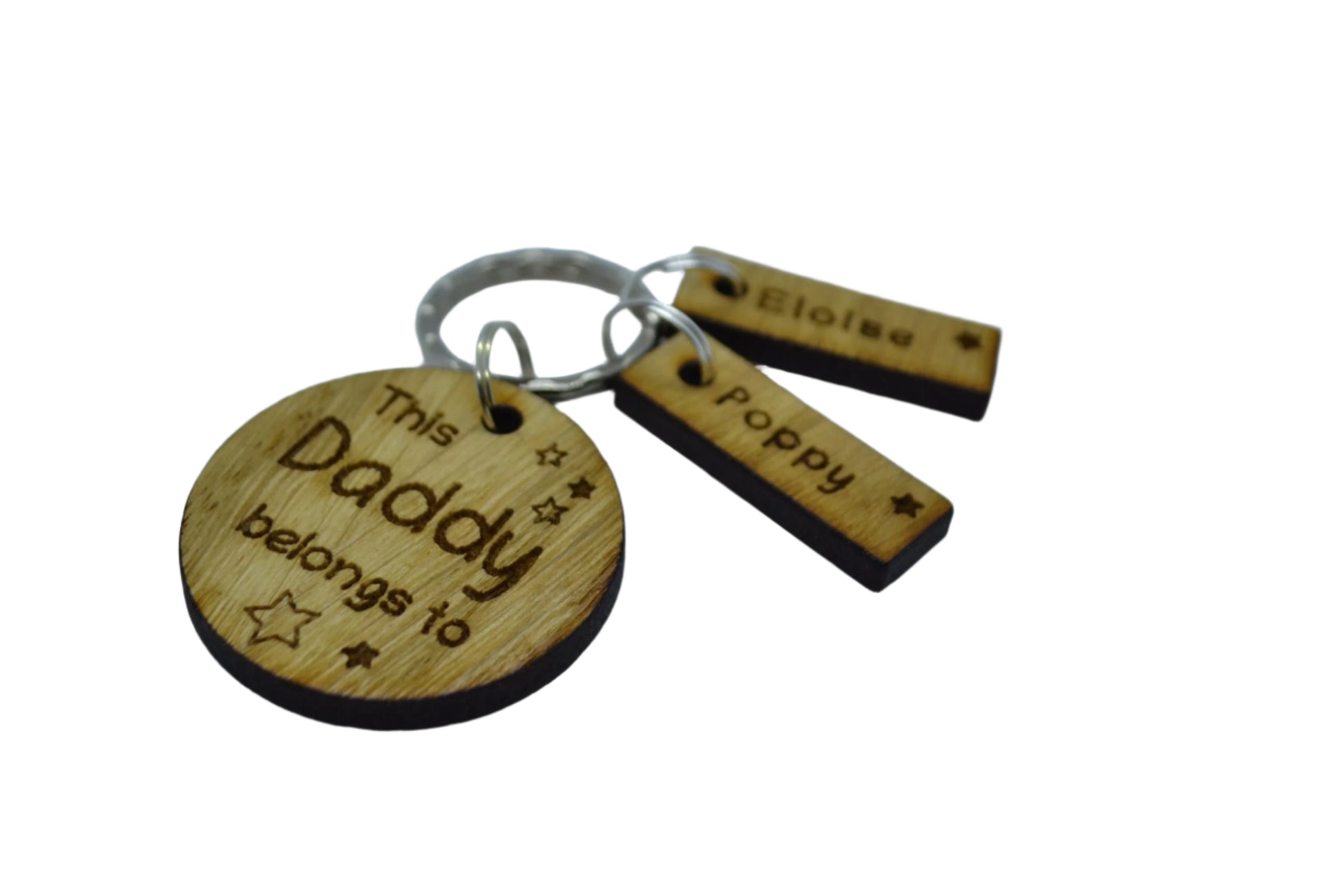 This Daddy Belongs To keychain with added charms, engraved with names and a star.