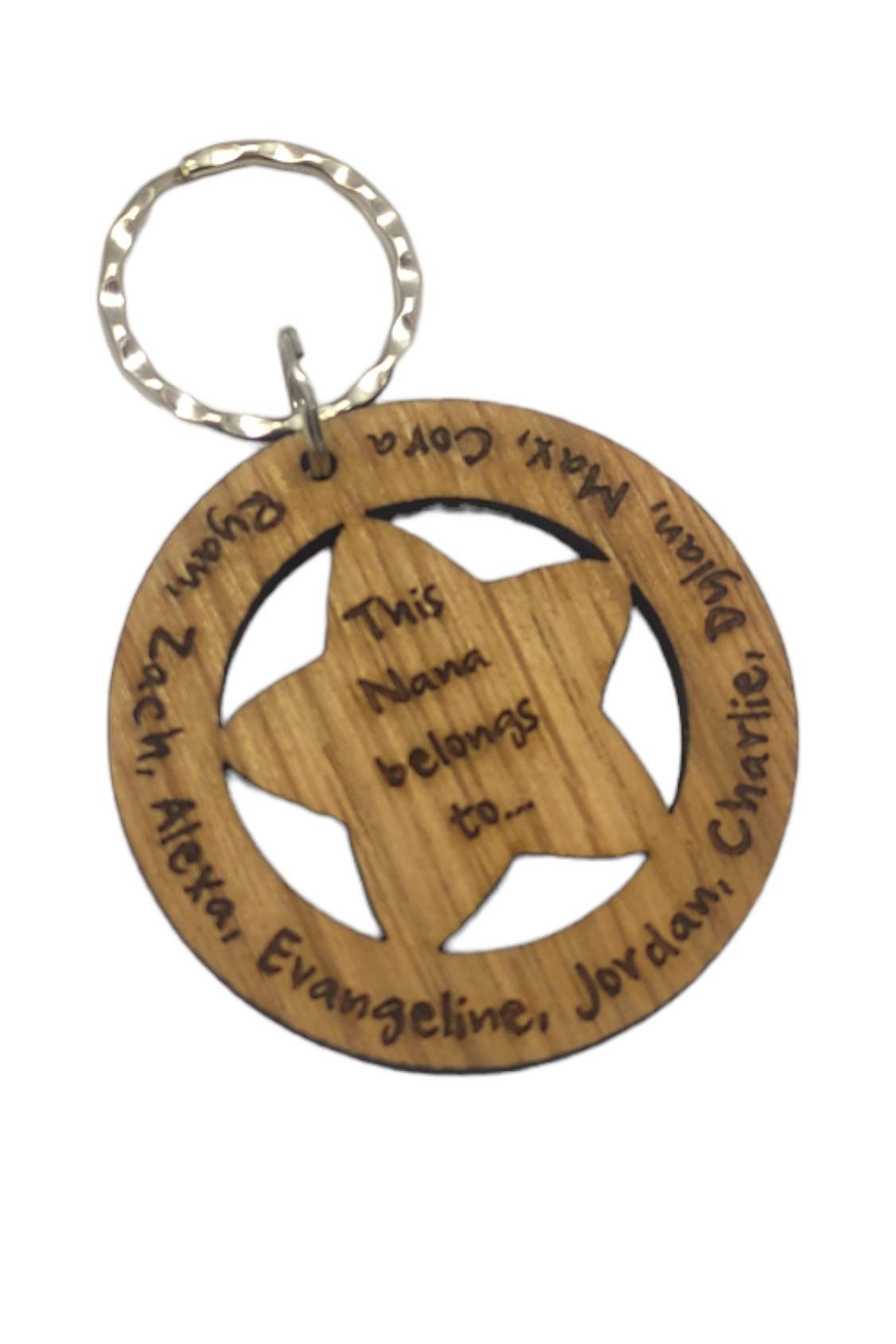 Circle keyring with family names engraved around the outside and a cut-out star in the middle, engraved with "This Nanny Belongs To..."