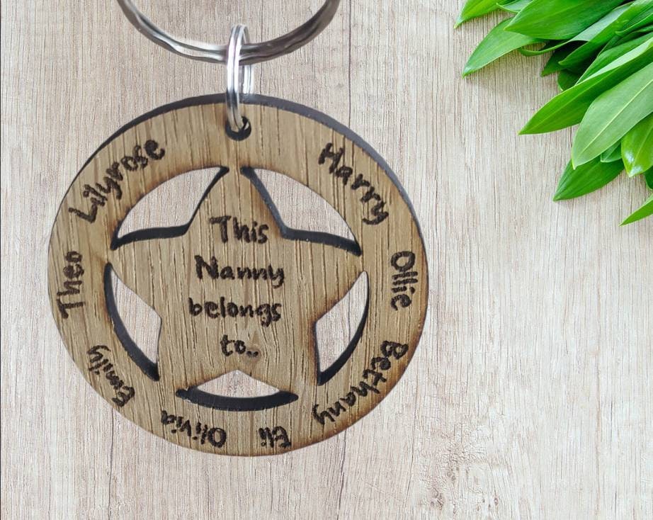 Circle keyring with family names engraved around the outside and a cut-out star in the middle, engraved with "This Nanny Belongs To..."