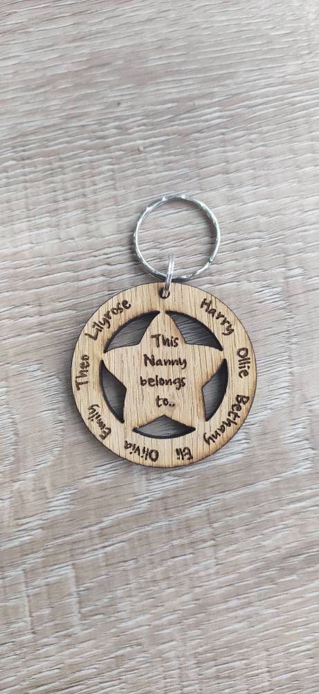 Circle keyring with family names engraved around the outside and a cut-out star in the middle, engraved with "This Nanny Belongs To..."