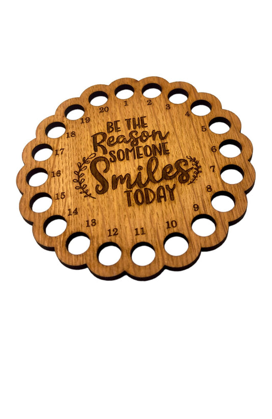 Thread holder with the words 'Be the reason someone smiles today' engraved in the middle, featuring 20 holes for organising embroidery threads.