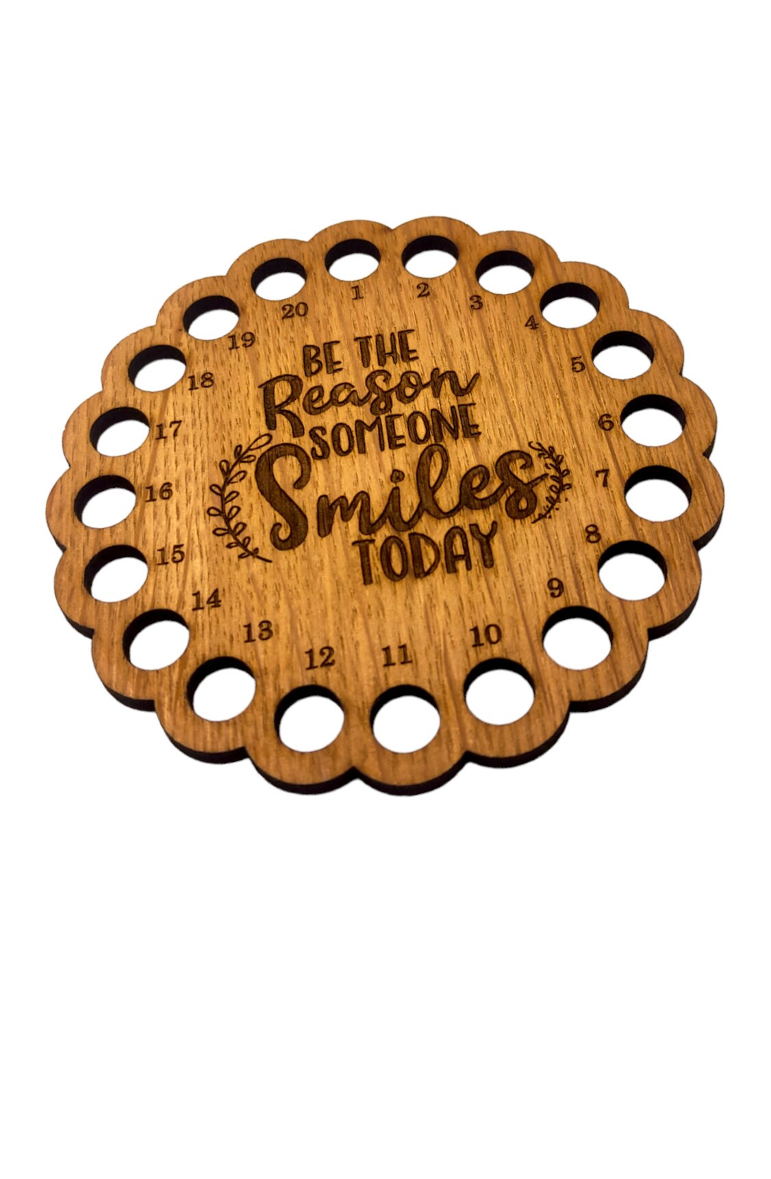 Thread holder with the words 'Be the reason someone smiles today' engraved in the middle, featuring 20 holes for organising embroidery threads.