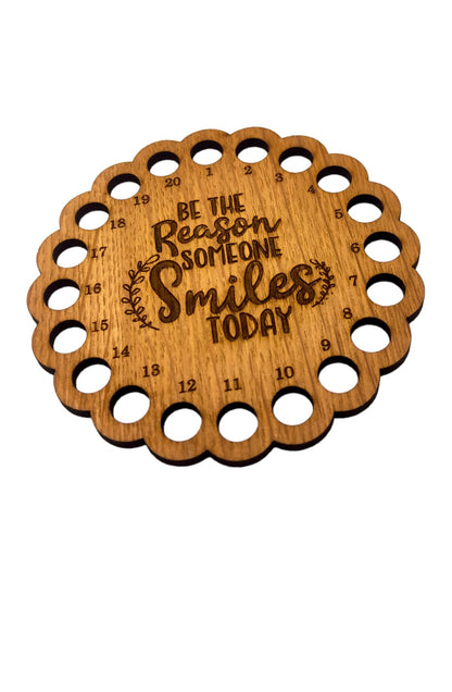 Thread holder with the words 'Be the reason someone smiles today' engraved in the middle, featuring 20 holes for organising embroidery threads.