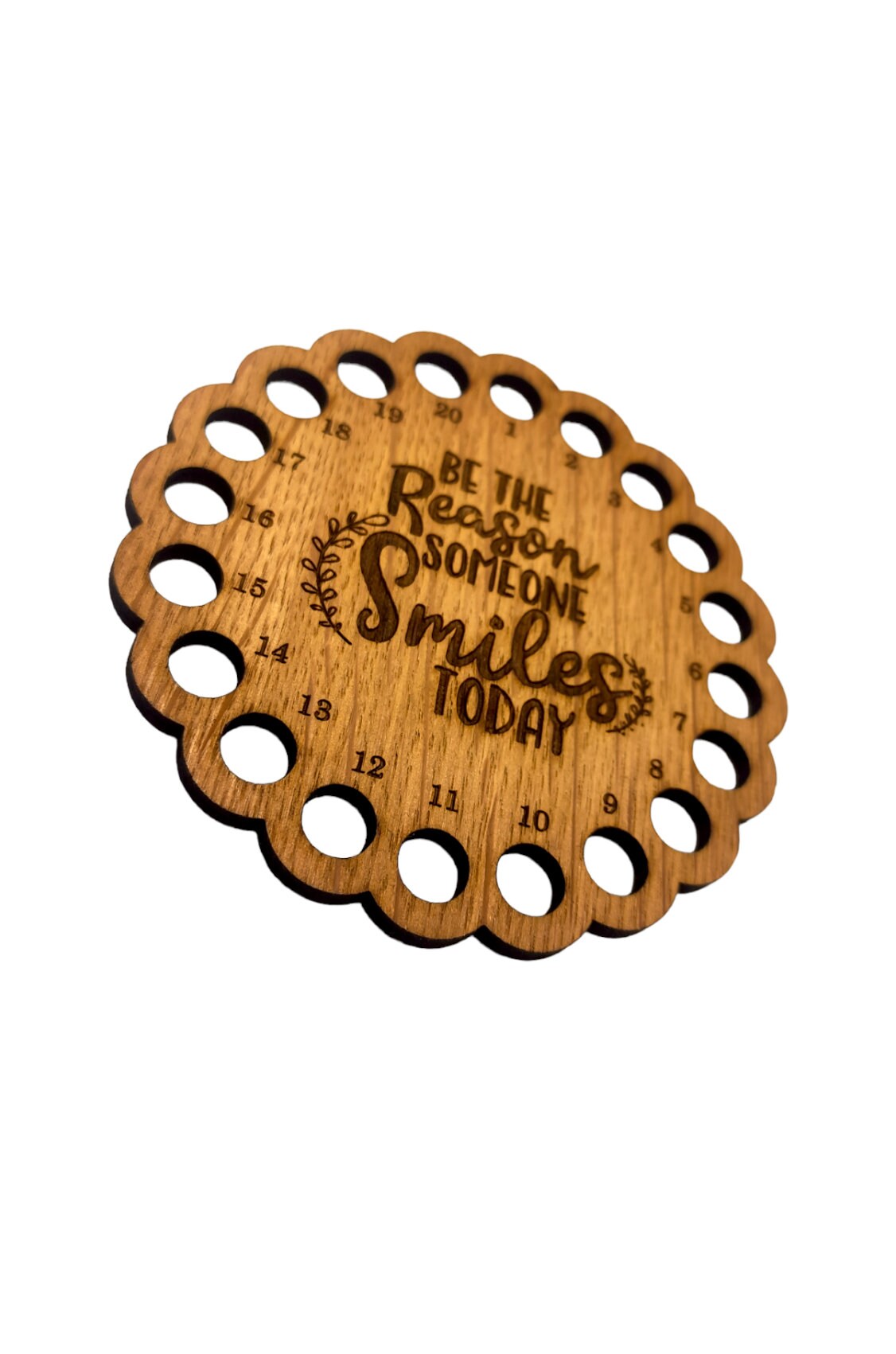 Thread holder with the words 'Be the reason someone smiles today' engraved in the middle, featuring 20 holes for organising embroidery threads.