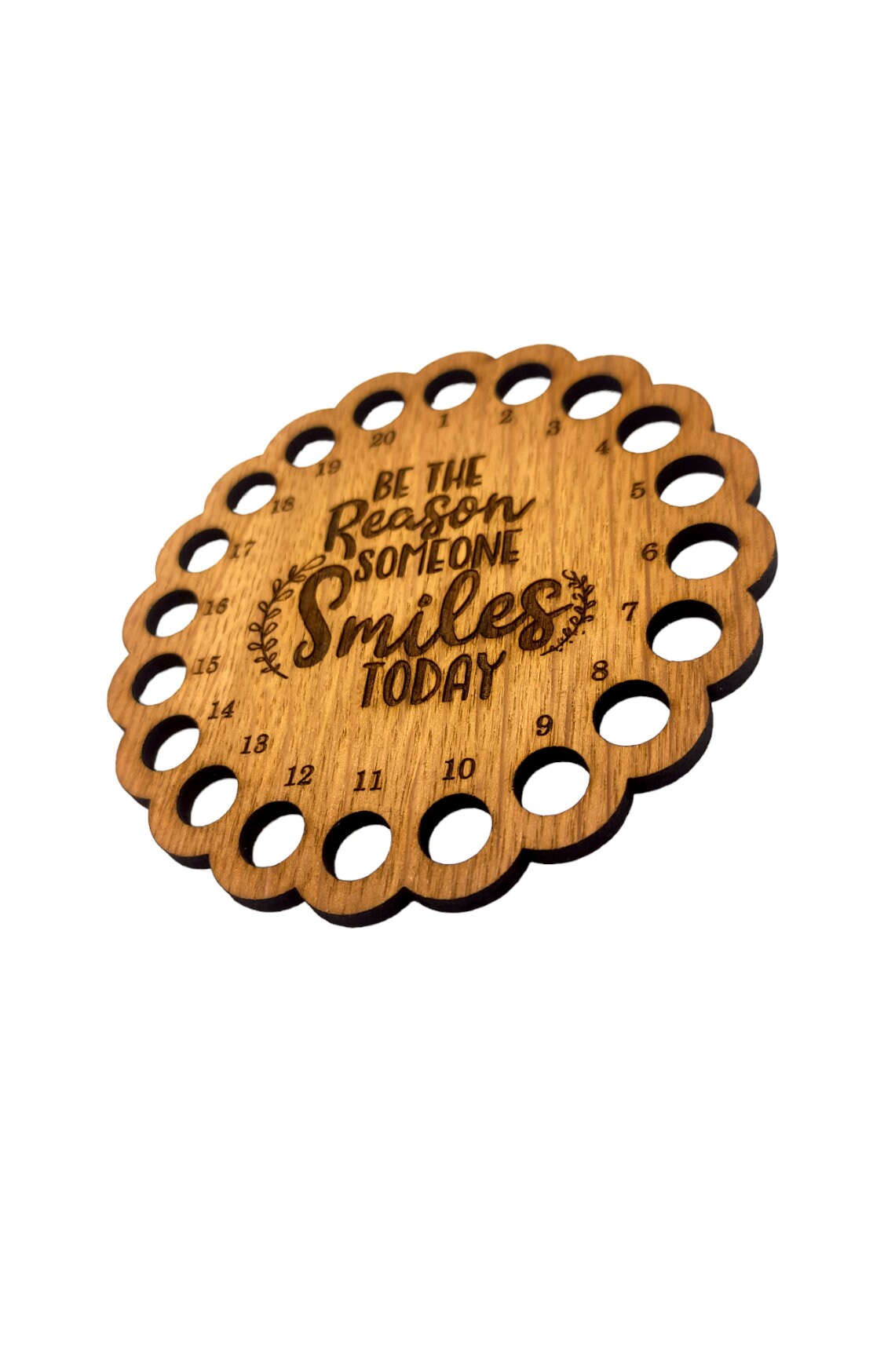 Thread holder with the words 'Be the reason someone smiles today' engraved in the middle, featuring 20 holes for organising embroidery threads.
