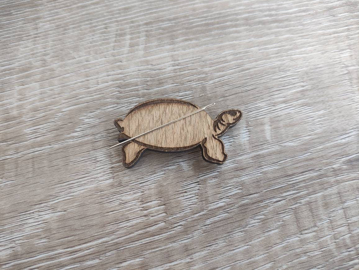 Tortoise-shaped needle minder, perfect for keeping needles secure while crafting.