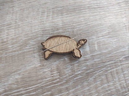 Tortoise-shaped needle minder, perfect for keeping needles secure while crafting.