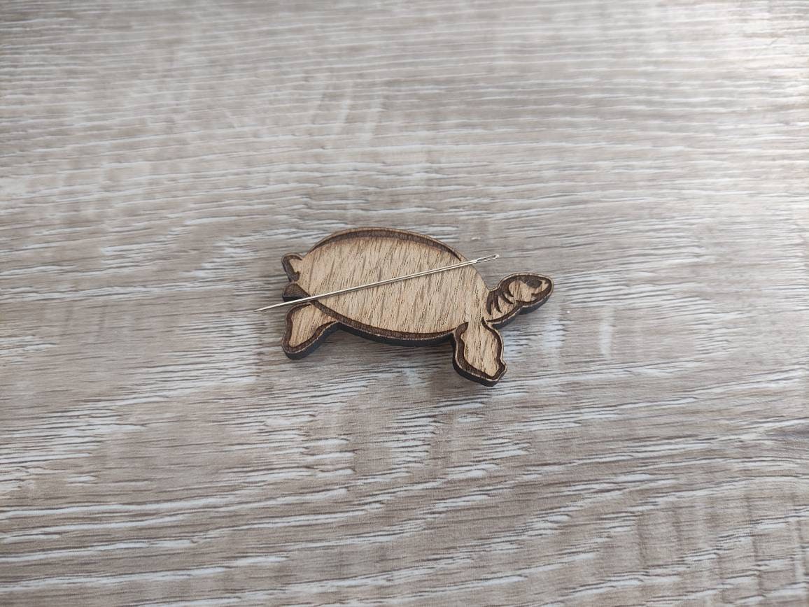 Tortoise-shaped needle minder, perfect for keeping needles secure while crafting.