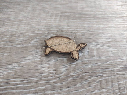 Tortoise-shaped needle minder, perfect for keeping needles secure while crafting.