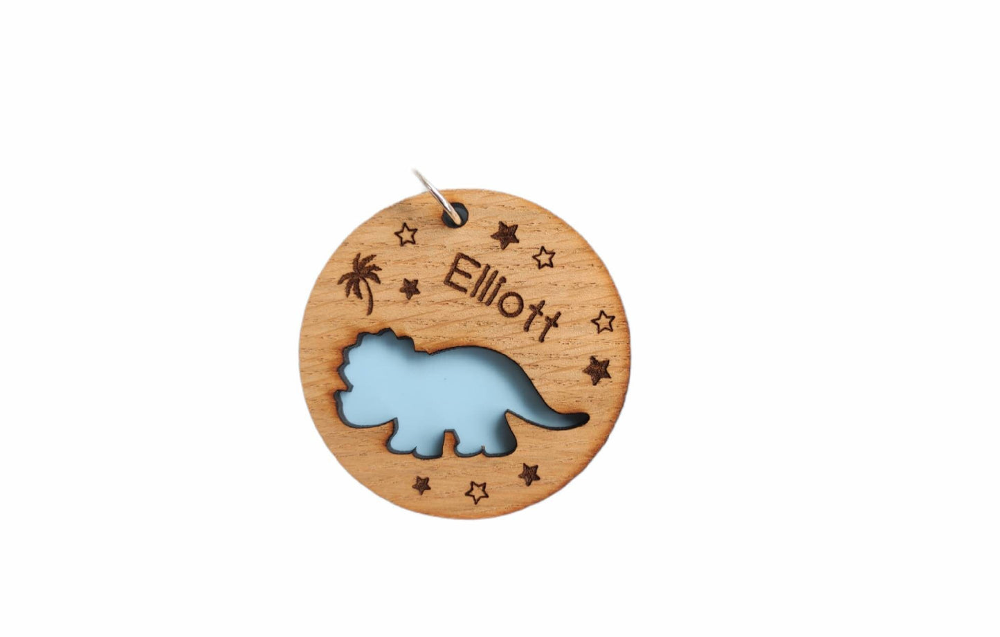 Round wooden keyring with a cut-out triceratops design, personalised with an engraved name, backed with colourful acrylic.
