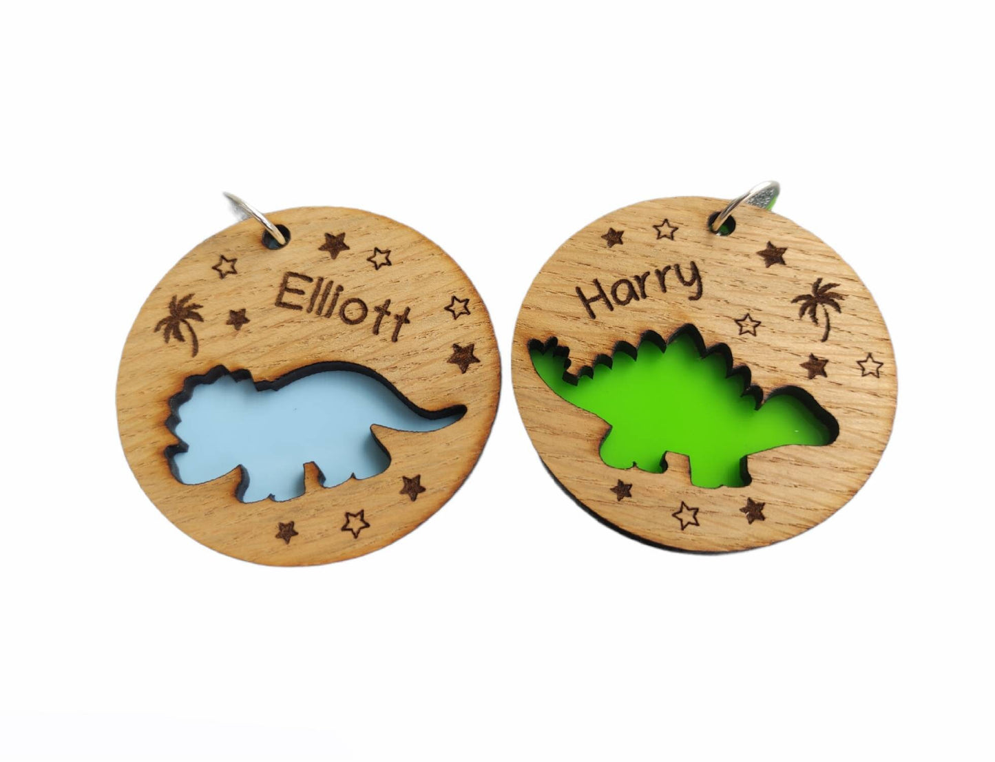 Round wooden keyring with a cut-out triceratops design, personalised with an engraved name, backed with colourful acrylic.