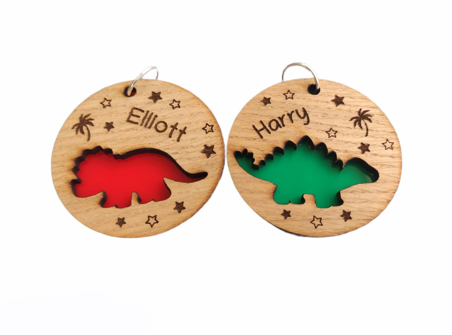 Round wooden keyring with a cut-out triceratops design, personalised with an engraved name, backed with colourful acrylic.