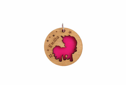 Circular wooden keyring with a unicorn cut-out, backed with colourful acrylic and personalised with an engraved name.
