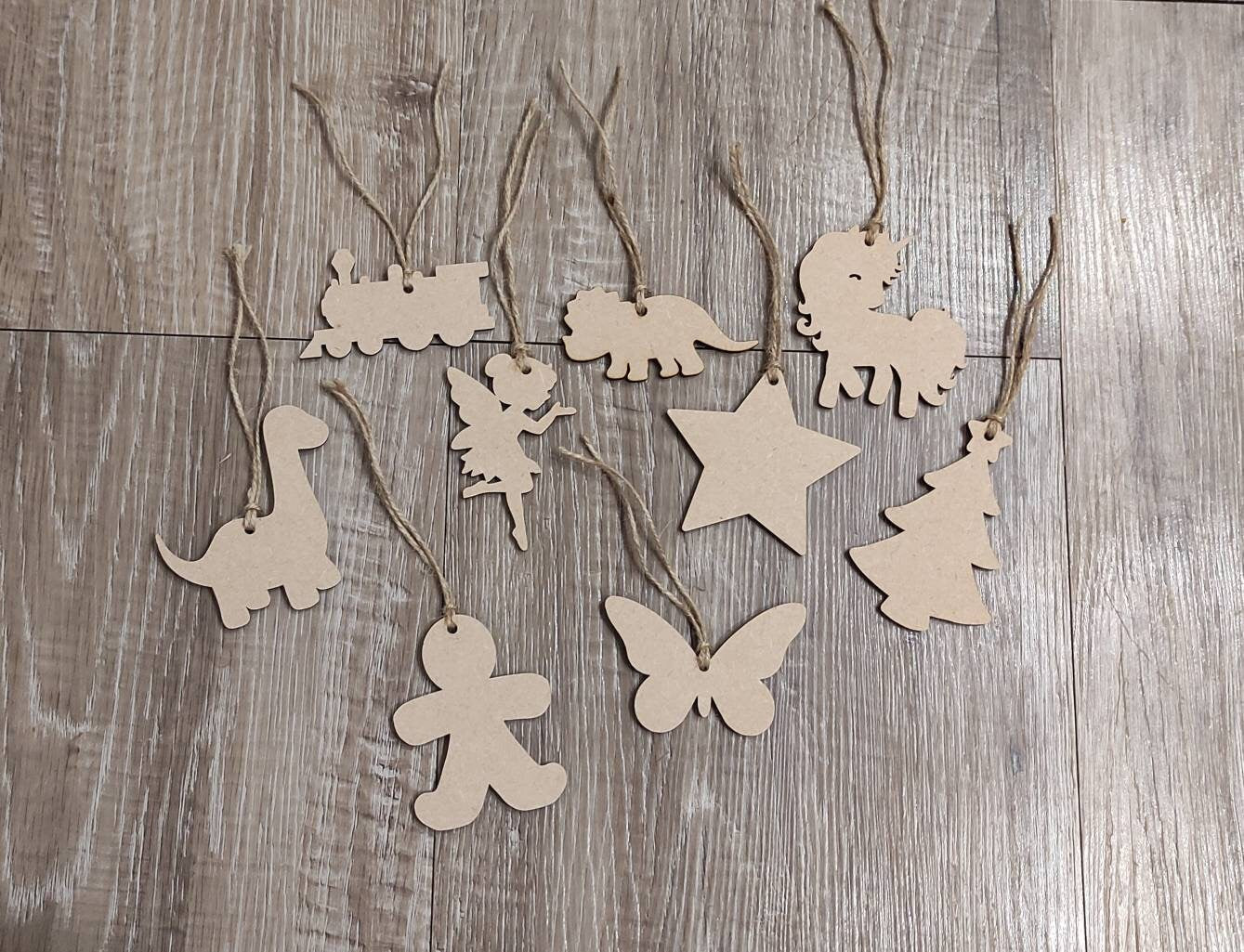 Wooden laser-cut shape with a hole at the top for hanging, string included, and 2 coloured pens inside a paper bag.