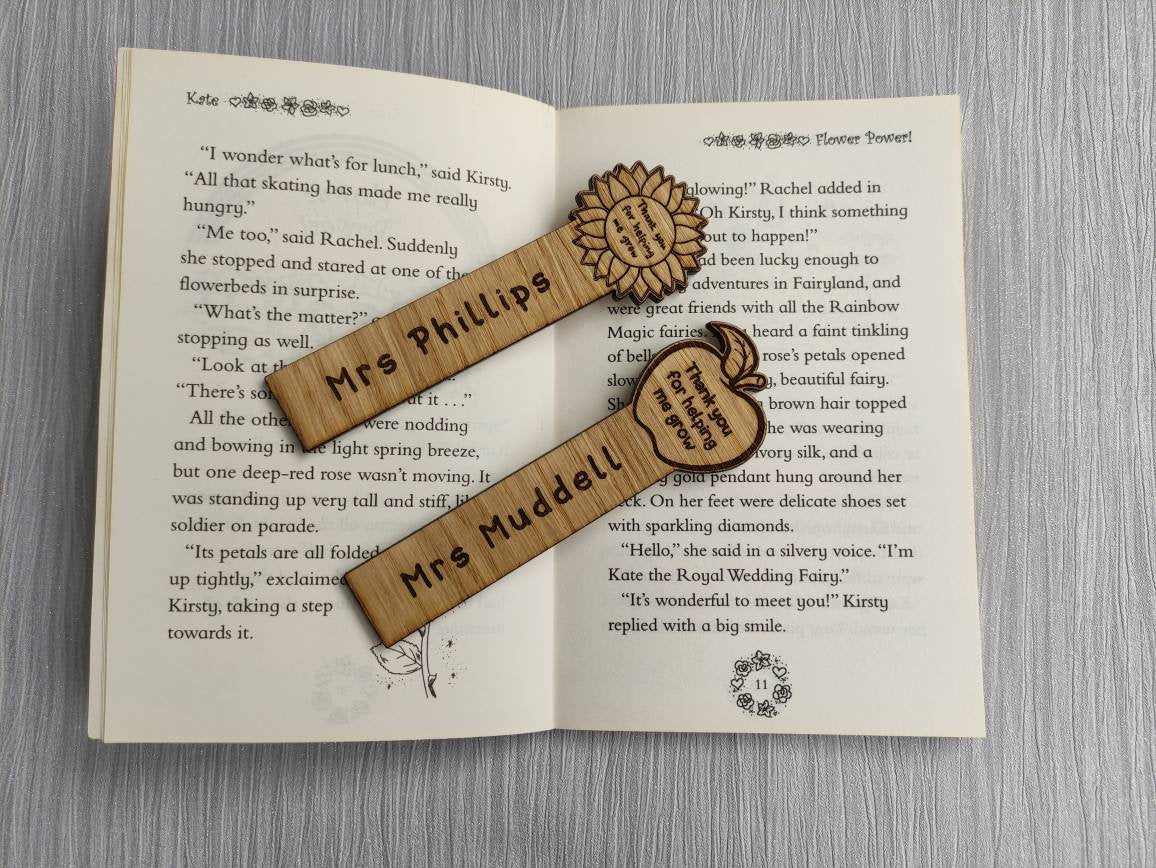 Wooden bookmark with custom name engraving, featuring a flower or apple design at the top.