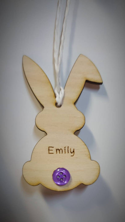 Easter bunny-shaped hanging decoration, engraved with a personalised name and featuring a coloured button as the tail.