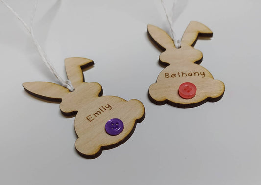 Easter bunny-shaped hanging decoration, engraved with a personalised name and featuring a coloured button as the tail.
