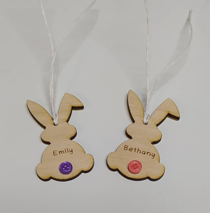 Easter bunny-shaped hanging decoration, engraved with a personalised name and featuring a coloured button as the tail.