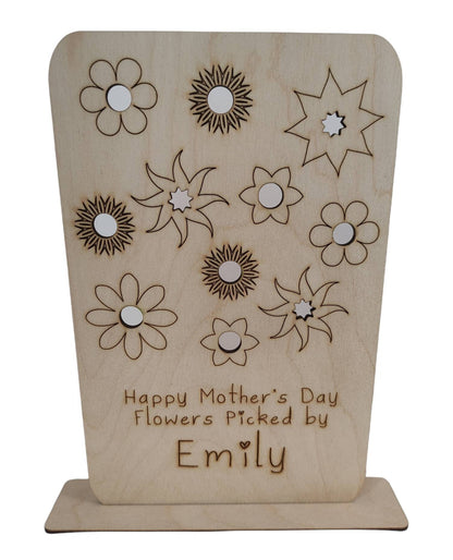 Personalised wooden floral decoration, intricately laser-engraved with flower designs and featuring holes to add your own blooms. 